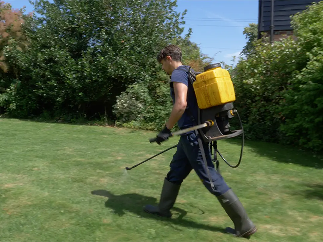 lawn operator spraying fertiliser application